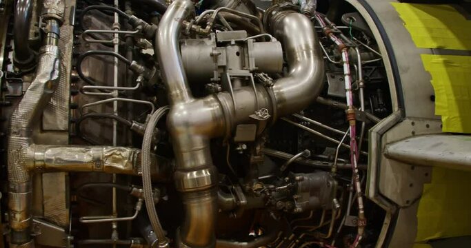 Concept of aircraft maintenance.  Close-up panning shot of a jet turbine engine.