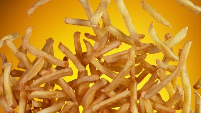 Super Slow Motion Shot of Flying Fresh French Fries. Filmed on High Speed Cinematic Camera at 1000 fps.