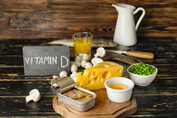 Different healthy products with vitamin D on wooden background - obrazy, fototapety, plakaty