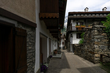 Old village with narrow cobblestone street and houses made of stone and wood