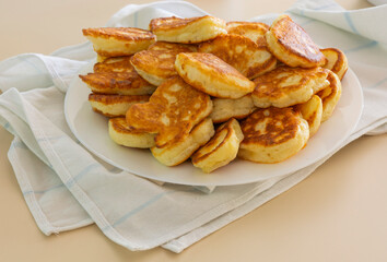 Freshly baked pancakes in a white plate on the table. Delicious morning breakfast with hot pancakes. homemade delicious fried