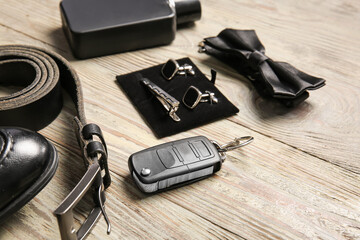 Stylish male accessories on wooden background, closeup