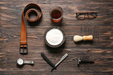 Stylish male accessories and glass of whiskey on wooden background