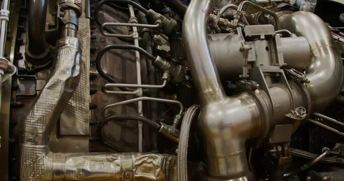 Concept of aircraft maintenance.  Close-up tilting shot of a jet turbine engine.