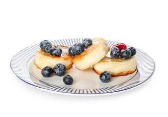 Plate with tasty cottage cheese pancakes and berries on white background