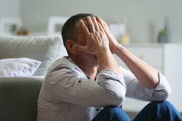 Depressed mature man at home