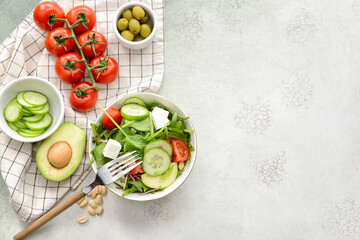 Plate with healthy salad on light background