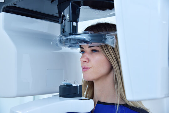 Woman patient make a x-ray picture on dental a tomograph in clinic