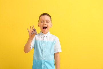 Little boy with letter A on color background