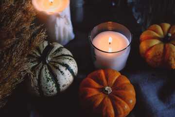 Cozy autumn home decor with candles and pumpking.