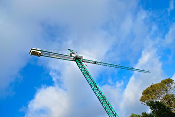 A very high crane on a building site, diagonal low angle perspective.
