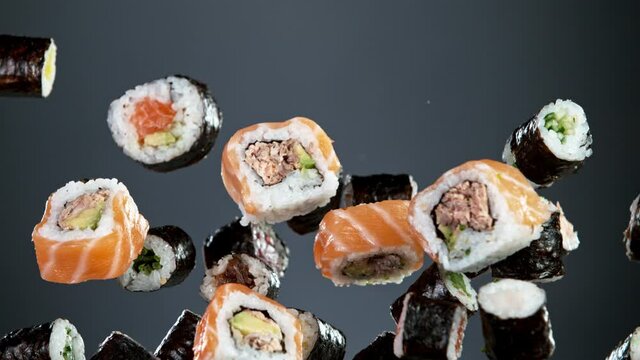 Super slow motion of flying sushi pieces on black background. Filmed on high speed cinema camera, 1000fps