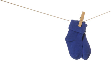 Baby socks hanging on rope against white background