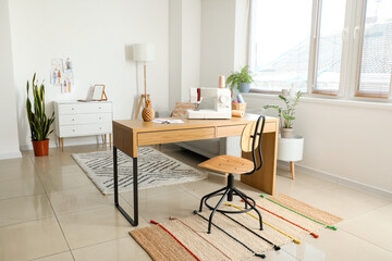 Fototapeta premium Modern home sewing studio with desk, sewing machine, and creative workspace for fashion design