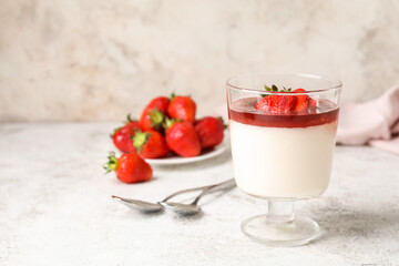 Tasty strawberry panna cotta on light background