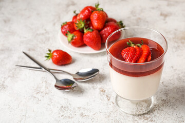 Glass with tasty strawberry panna cotta on white background, closeup