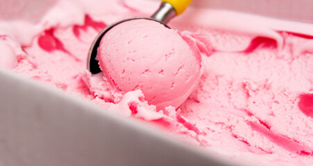 Close-up detail -Scooping ice cream ball strawberry.