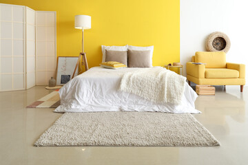 Stylish bright bedroom with modern furniture