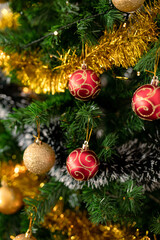Baubles, chains and other decorations hanging on christmas tree