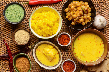Traditional Indian food with spices on wicker mat