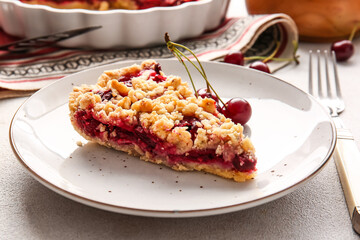 Plate with piece of tasty cherry pie on light background, closeup
