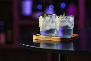 Glasses of cold gin tonic on table in bar