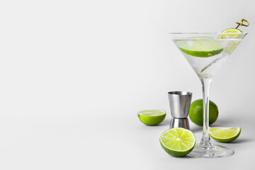 Glass of tasty gin and tonic on light background