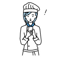 立ってスマートフォンを操作して何かに気づいて驚いた調理師の女性