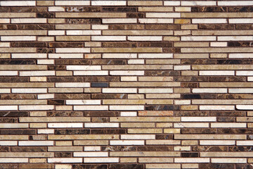 Full frame close-up view of a building wall with marble strips in various colors