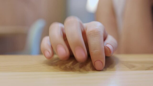 Impatient person tapping on the table with fingers