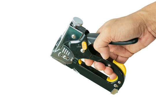 Man hand holding a construction stapler on a white background. Heavy-duty steel staple gun to repairs or DIY around your home. Selective focus.