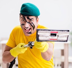 Funny man in military style cleaning the house