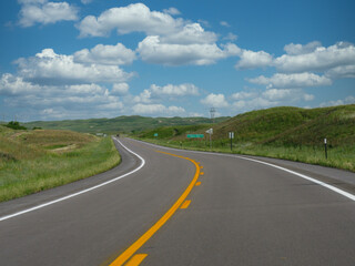 Fototapeta na wymiar Winding road and beautiful clouds, Nebraska landscape, USA.