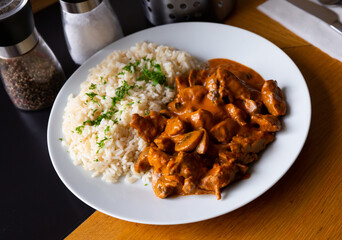 Tasty beef stroganoff with rice and parsley. Czech cuisine