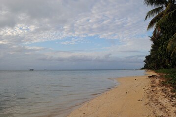 A stretch of empty beach with fine sand on Saipan, Northern Mariana Islands.