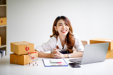 Portrait of Starting small businesses SME owners female entrepreneurs working on receipt box and check online orders to prepare to pack the boxes, sell to customers, sme business ideas online.
