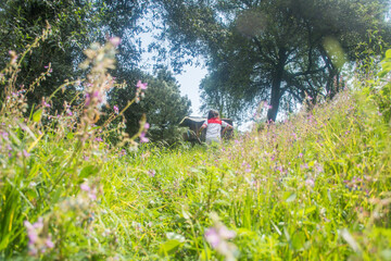 Girl walking in field with hut in the background