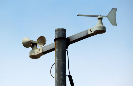 view of a windpane and anemometer against blue sky
