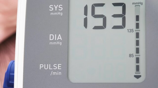 Man check blood pressure monitor and heart rate monitor with digital pressure gauge. Health care and Medical concept