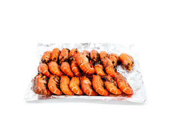 Arrange grilled river prawns on foil to deliver to customers ordering food online.