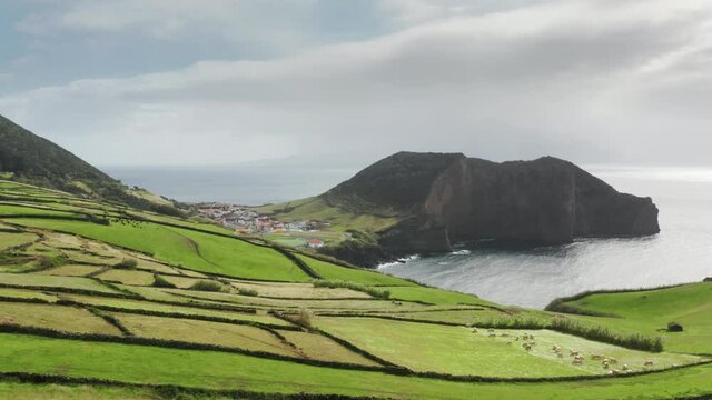 Sao Jorge island, Azores, Portugal. Drone footage of the volcanic cliffs washed with the sea. Picturesque archipelago covered with lush greenery. High quality 4k footage