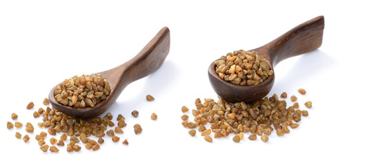 uncooked buckwheat in the wooden spoon, isolated on the white background