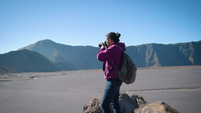 Asian young photographer in the mountain