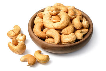 roasted chshew nuts in the wooden bowl, isolated on the white background