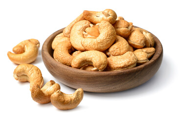 roasted chshew nuts in the wooden bowl, isolated on the white background