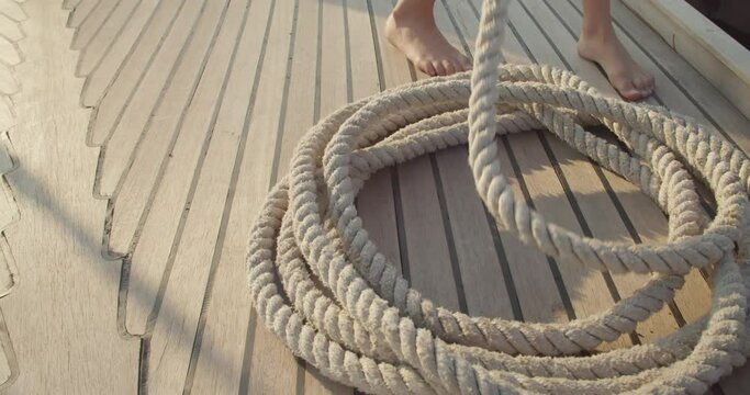 Sailor using rope on yacht
