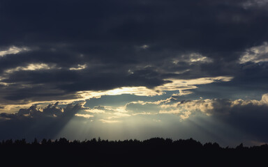 Dark Dramatic Sky with Sunbeams Through Storm Clouds - 458649438