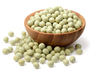 uncooked dried green peas in the wooden bowl, isolated on the white background