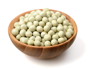 uncooked dried green peas in the wooden bowl, isolated on the white background