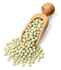 uncooked dried green peas in the wooden scoop, isolated on the white background